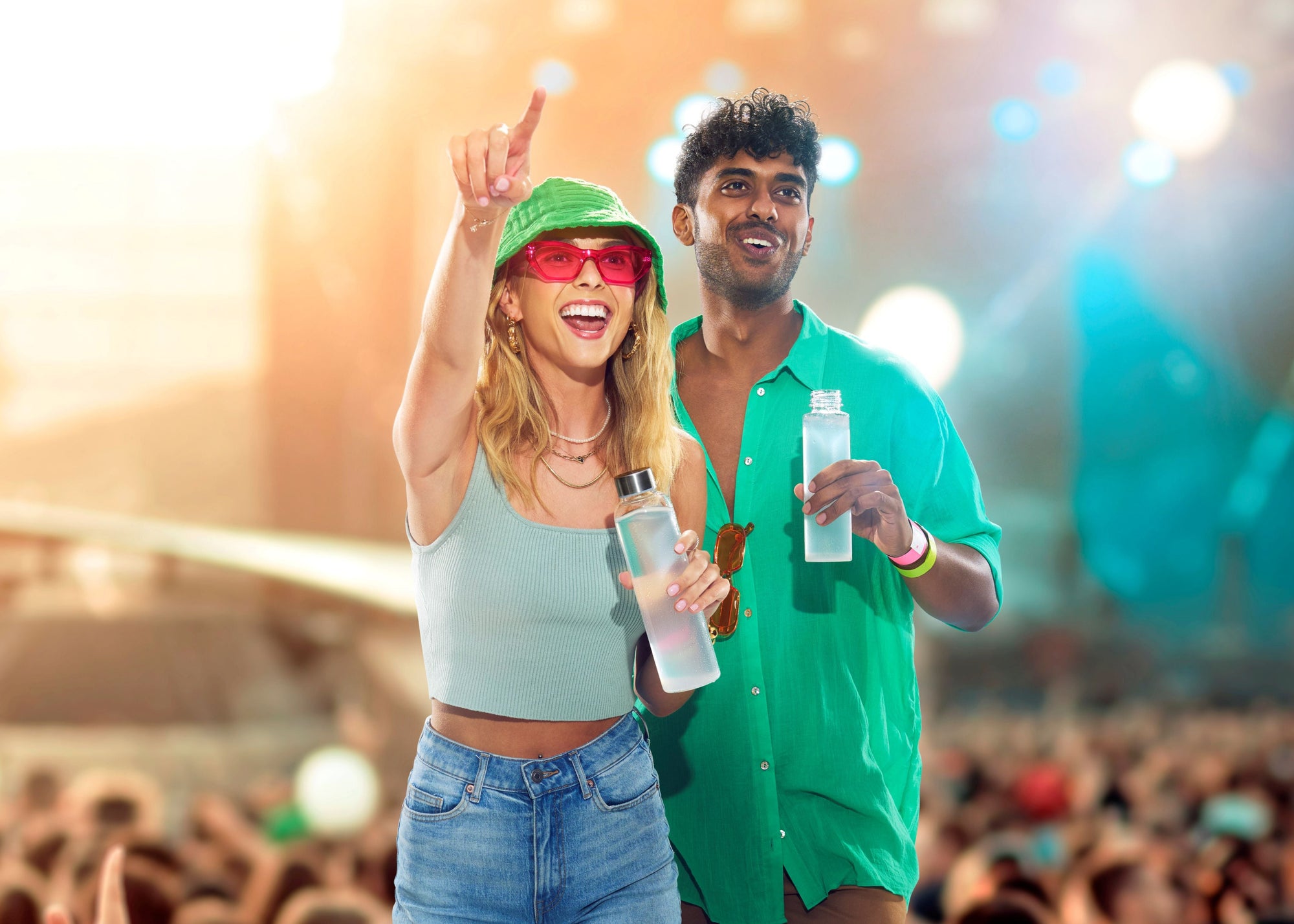 A couple dancing joyfully at a colorful music festival.